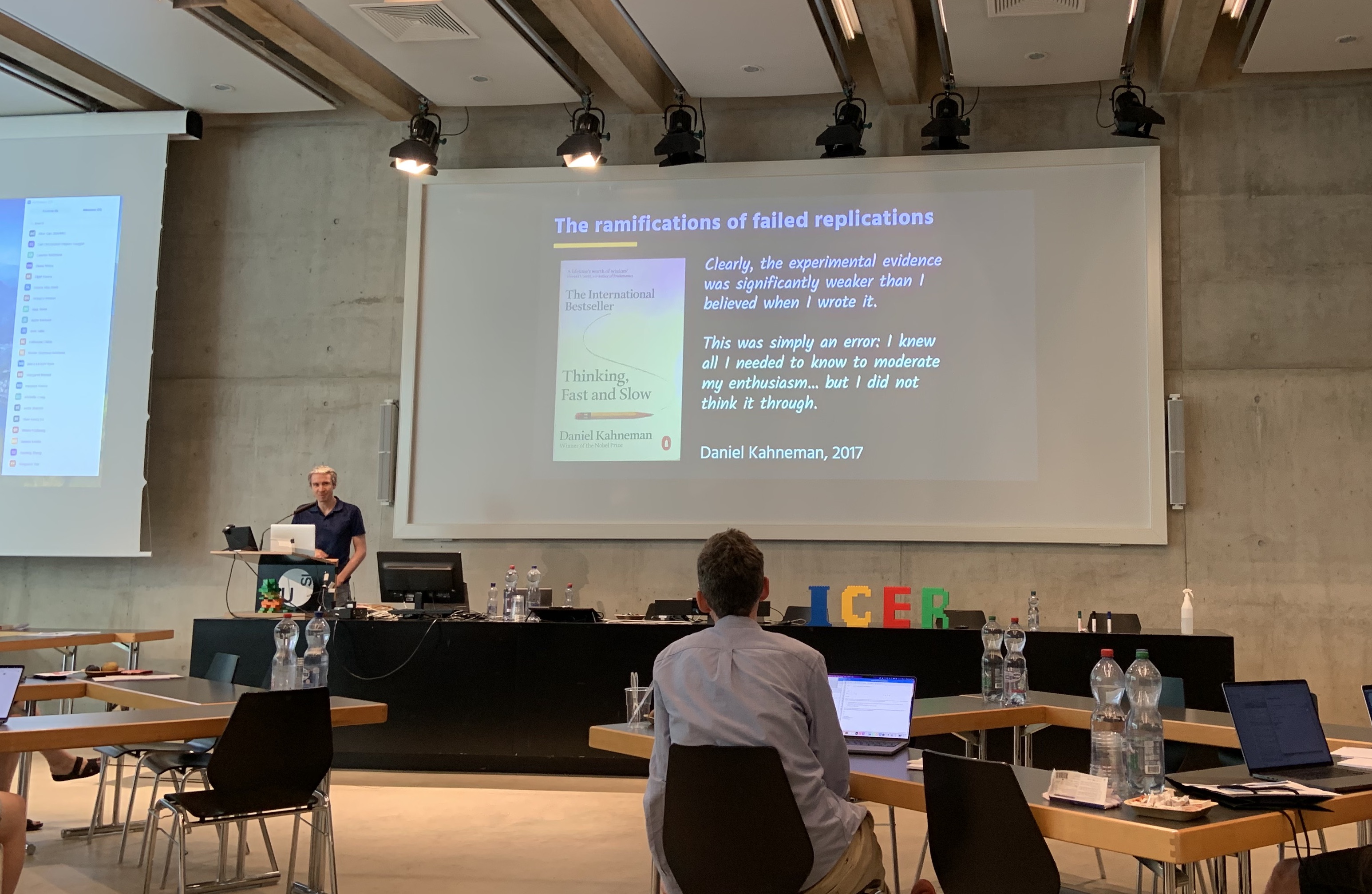 Neil Brown at the ICER stage with a quote from Daniel Kahneman: 'Clearly, the experimental evidence was significantly weaker than I believed when I wrote it.'