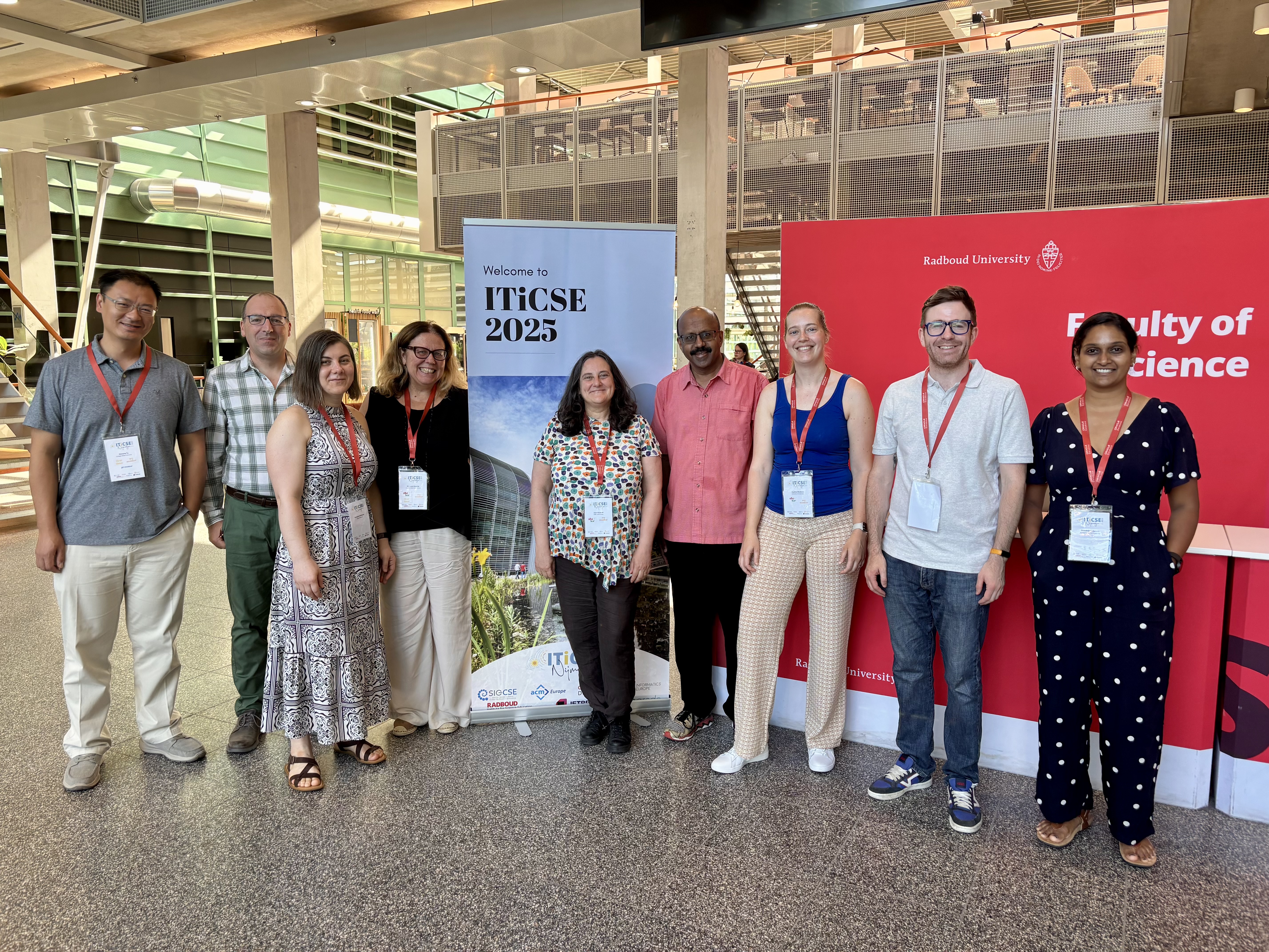 The working group members pose with the ITiCSE 2025 logo.